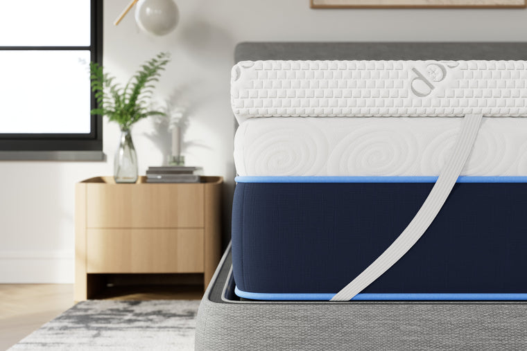 Elastic corner strap holding the DreamAlign topper in place on a mattress